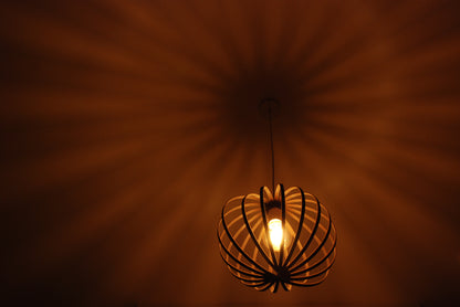 LUWALD NO.03 S Pendelleuchte aus Holz, weiß, handgefertigt, kugelförmig, angeschaltet, Decke Schatten, warm