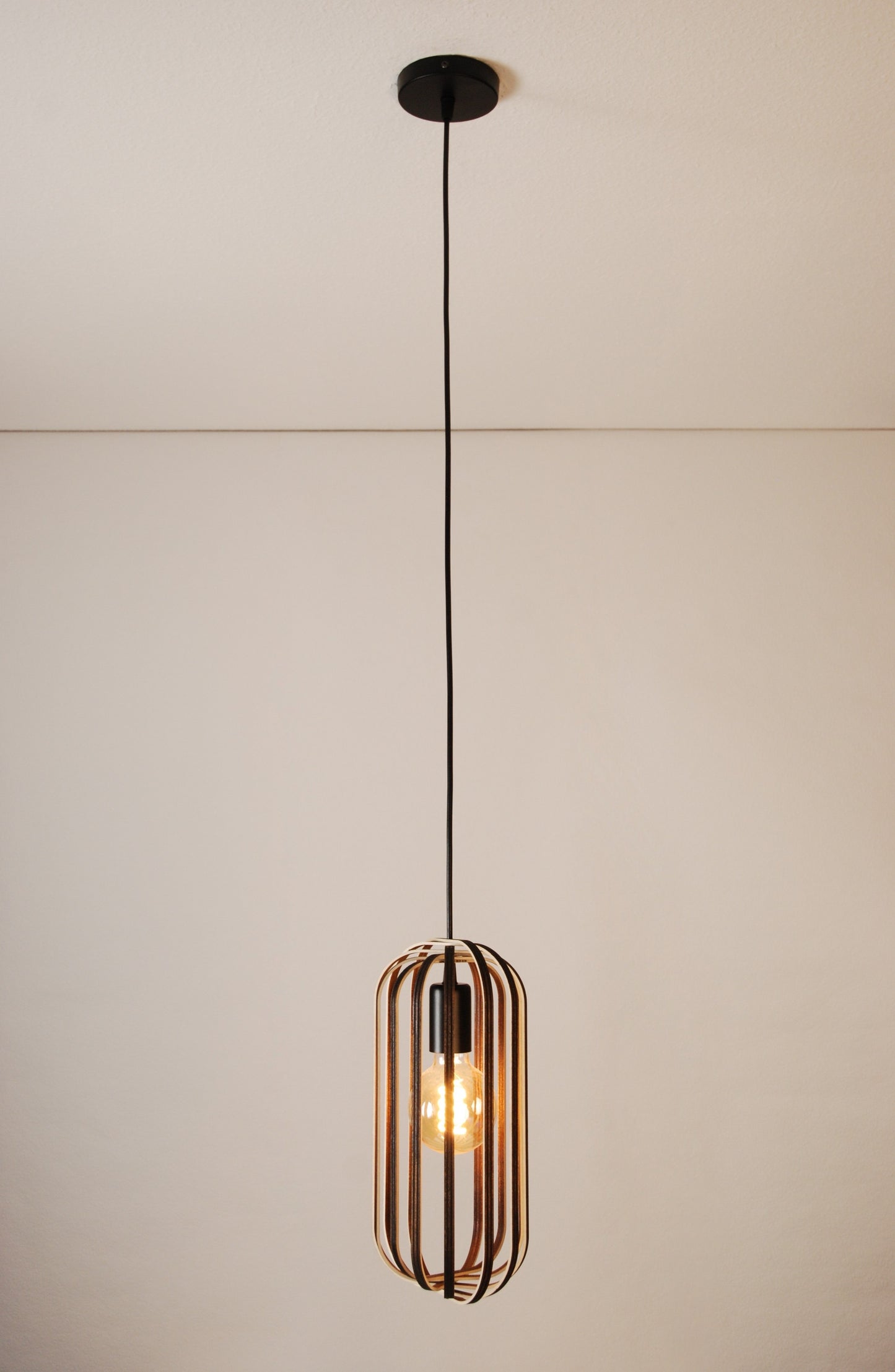 LUWALD NO.04 S Pendelleuchte aus Holz, schwarz, handgefertigt, zylinderförmig, angeschaltet, Ringe, Atmosphäre, Hängelampe,  warm, Gesamtansicht, Deckenmontage, gemütlich