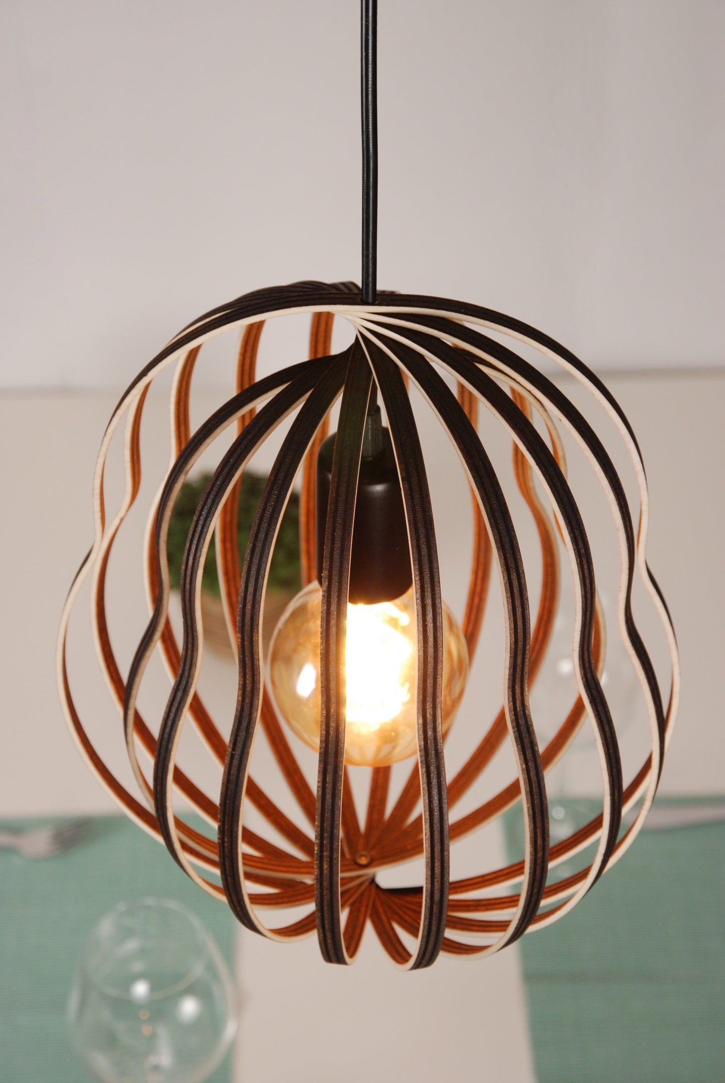 LUWALD NO.02 M Pendelleuchte aus Holz, schwarz, handgefertigt, birnenförmig, angeschaltet, schräg von oben